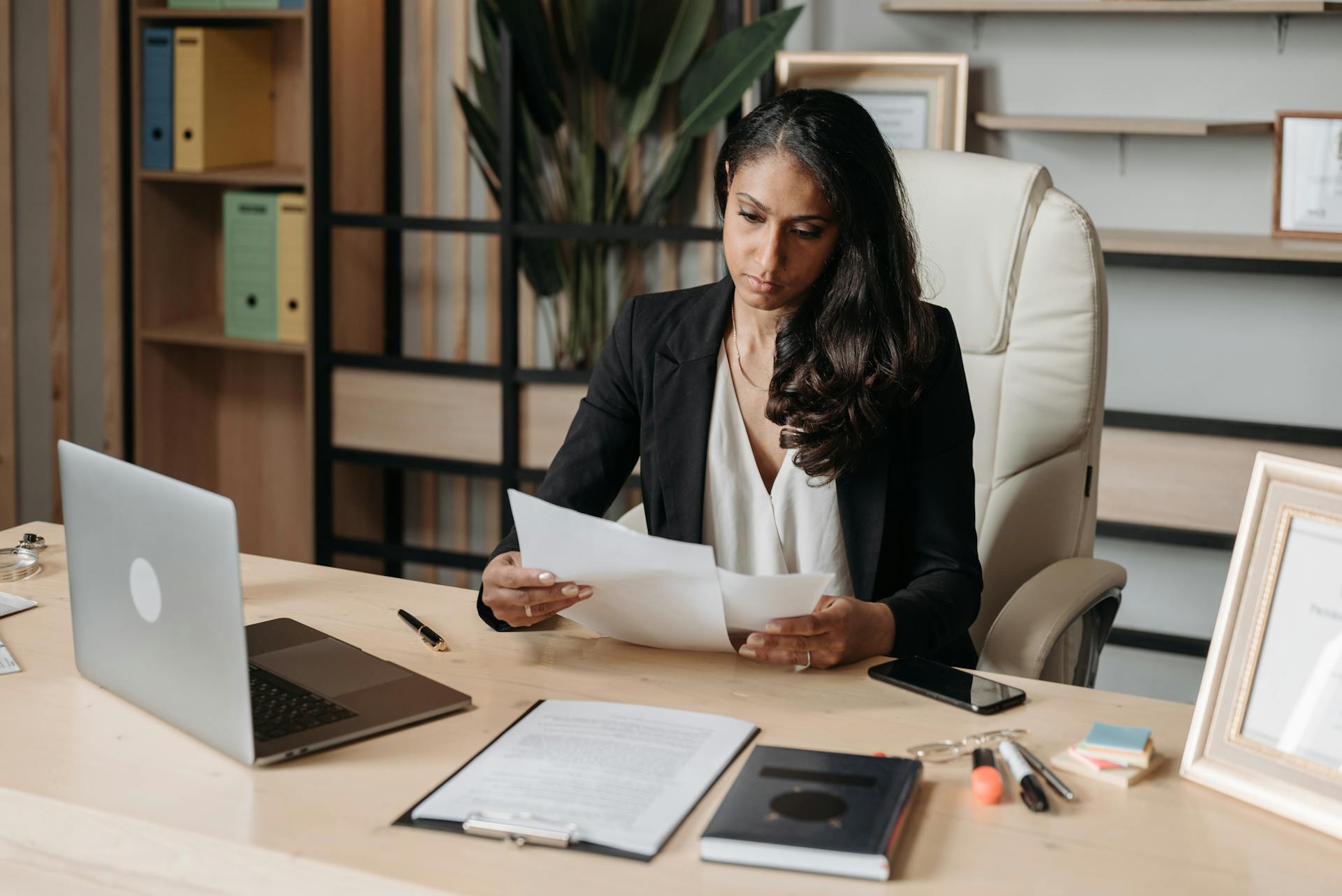business woman looking over documents in office